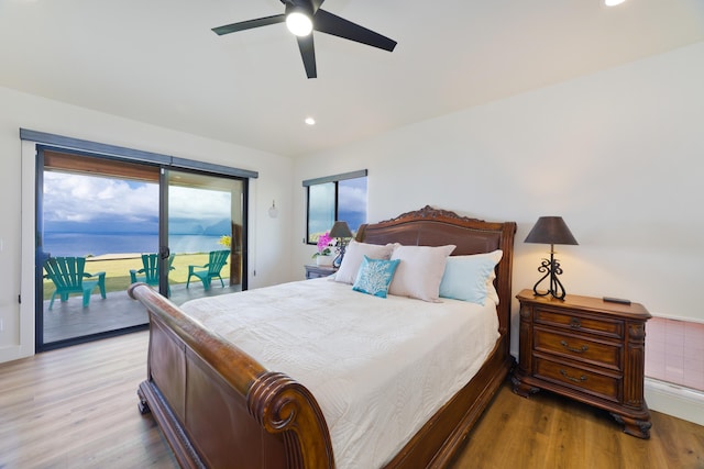 bedroom featuring access to exterior, light hardwood / wood-style flooring, and ceiling fan