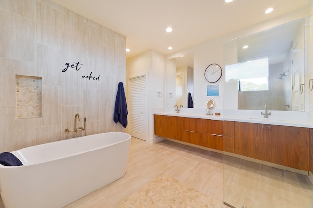 bathroom featuring tile walls, vanity, and separate shower and tub