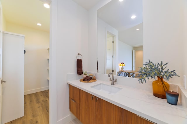 bathroom with hardwood / wood-style flooring and vanity