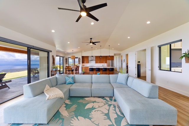 living room featuring vaulted ceiling and light wood-type flooring