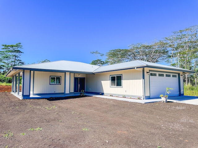 ranch-style house with covered porch and a garage