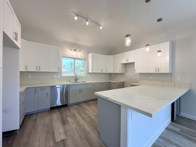 kitchen with pendant lighting, dishwasher, and white cabinetry