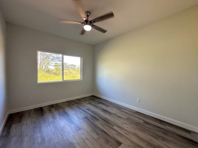 spare room featuring ceiling fan and dark wood-type flooring