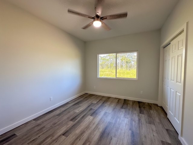 unfurnished bedroom featuring a closet, ceiling fan, and hardwood / wood-style floors