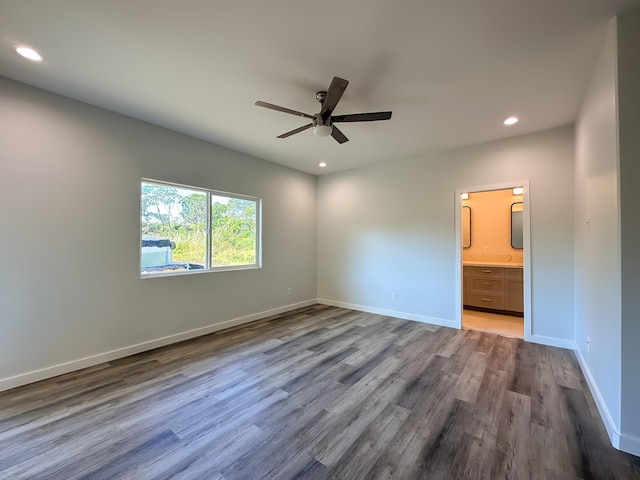 unfurnished bedroom with hardwood / wood-style flooring, ceiling fan, and ensuite bath