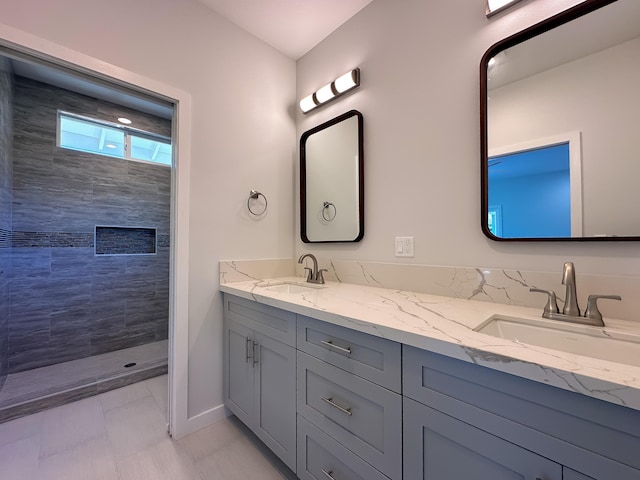 bathroom featuring vanity and tiled shower