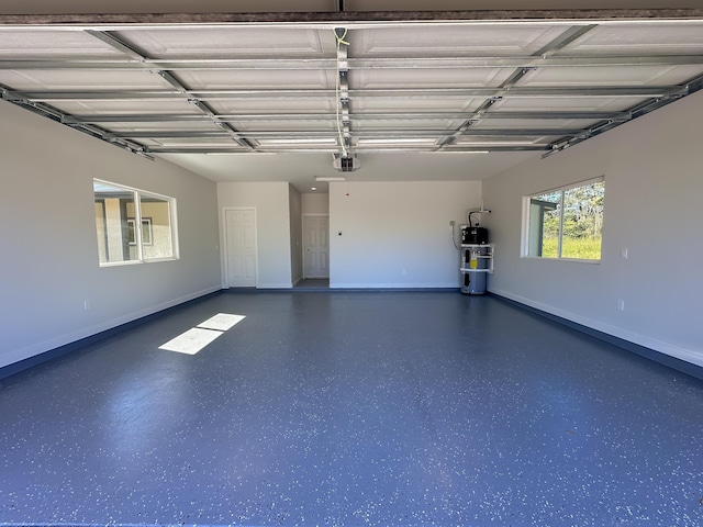 garage with heat pump water heater and a garage door opener