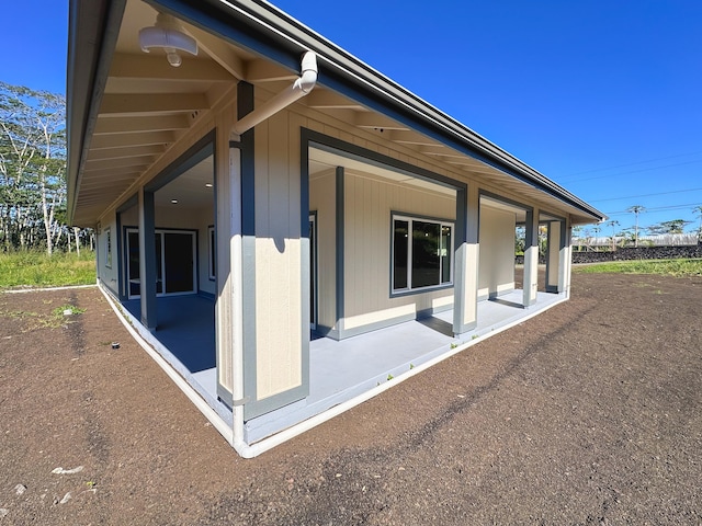 view of side of property featuring a patio