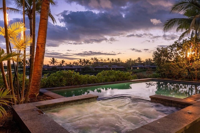 view of pool at dusk