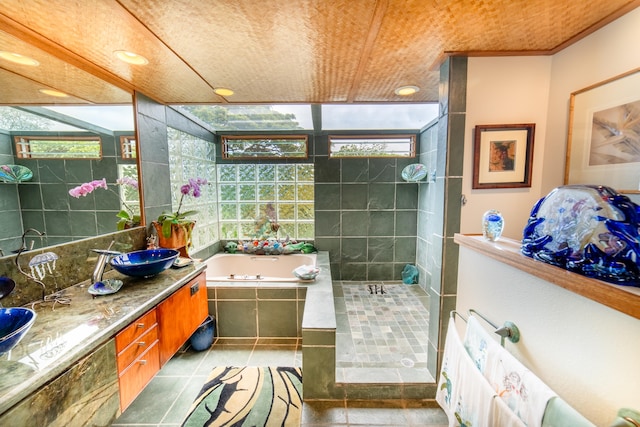 bathroom featuring shower with separate bathtub, vanity, tile patterned floors, and a healthy amount of sunlight