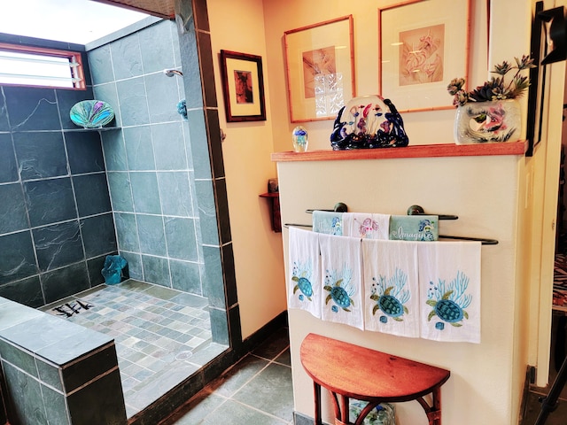 bathroom with tile patterned floors and a tile shower