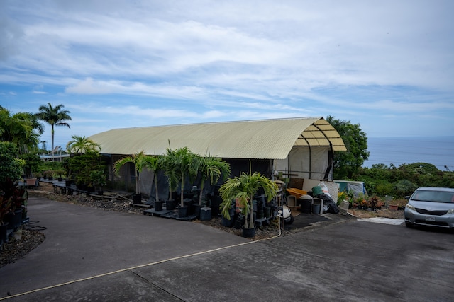 exterior space featuring a water view and a carport