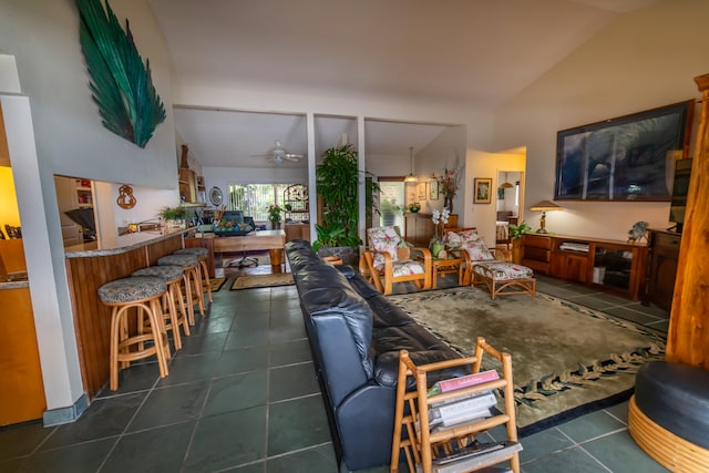 tiled living room with ceiling fan and vaulted ceiling