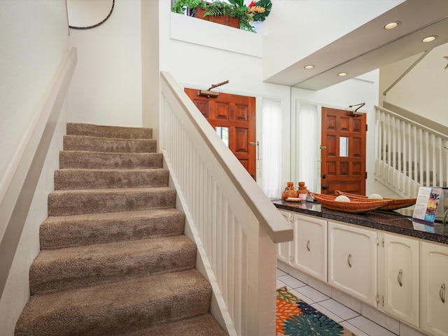 staircase with tile patterned floors