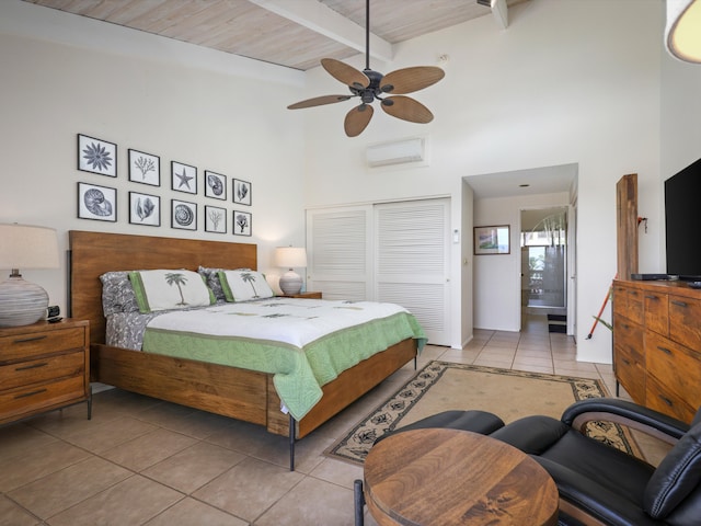 tiled bedroom featuring beam ceiling, ceiling fan, wooden ceiling, a wall mounted air conditioner, and a high ceiling