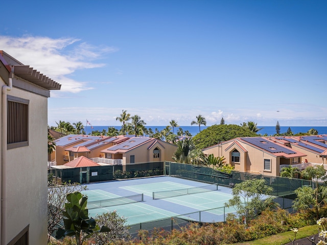 view of sport court featuring a water view