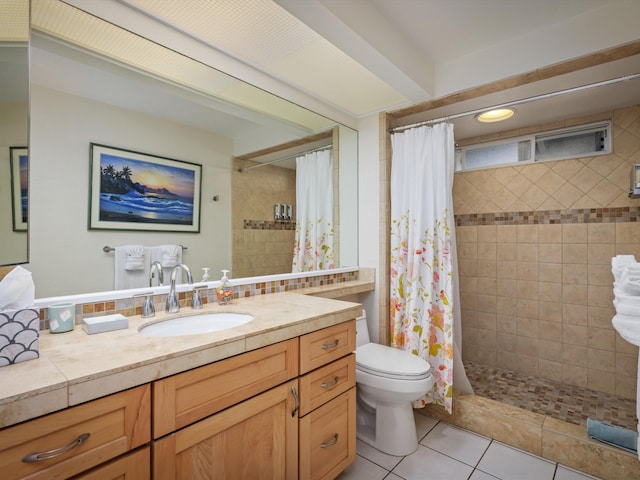 bathroom featuring tile patterned flooring, vanity, a shower with shower curtain, and toilet