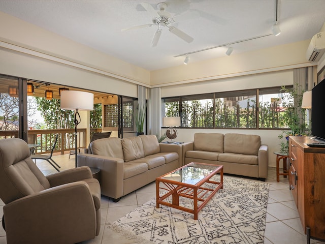 tiled living room featuring a textured ceiling, rail lighting, ceiling fan, and a healthy amount of sunlight