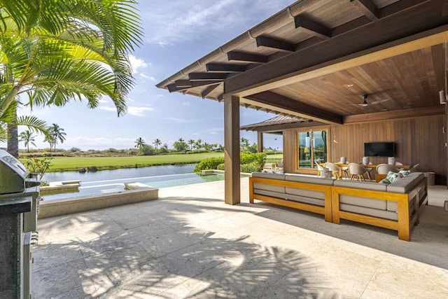 view of patio featuring an outdoor living space, a water view, and ceiling fan