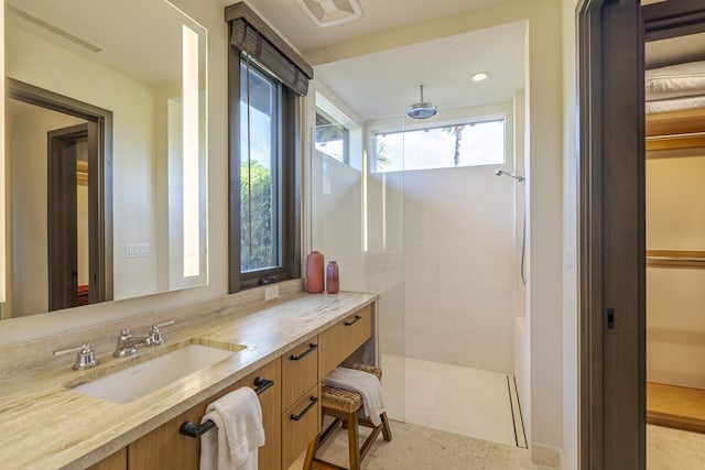 bathroom featuring a shower, tile patterned floors, and vanity