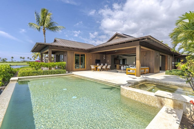 view of pool featuring an in ground hot tub, a patio area, and outdoor lounge area