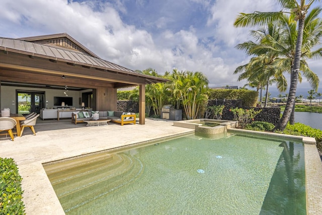 view of pool featuring an in ground hot tub, a patio area, an outdoor hangout area, and ceiling fan