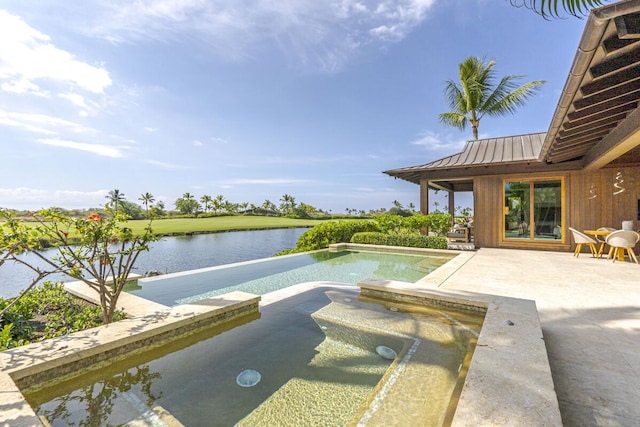 view of pool with a water view and a patio area