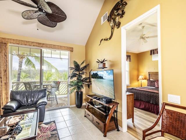 tiled living room featuring ceiling fan and lofted ceiling