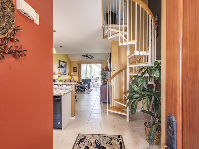 tiled foyer featuring ceiling fan and lofted ceiling