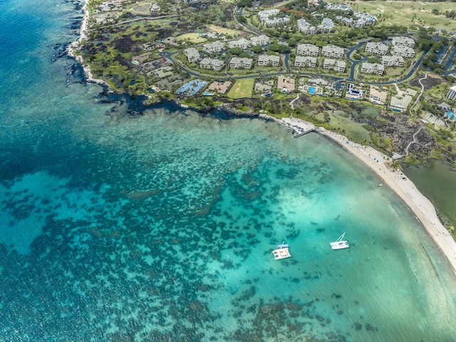 drone / aerial view featuring a water view and a view of the beach