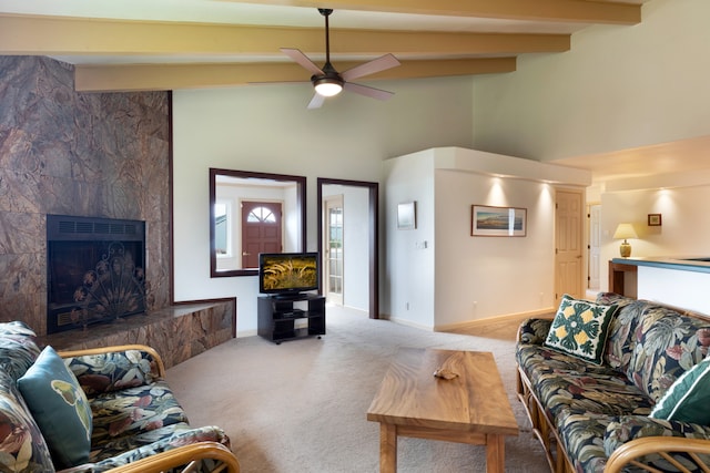 living room with ceiling fan, a premium fireplace, carpet flooring, and beam ceiling