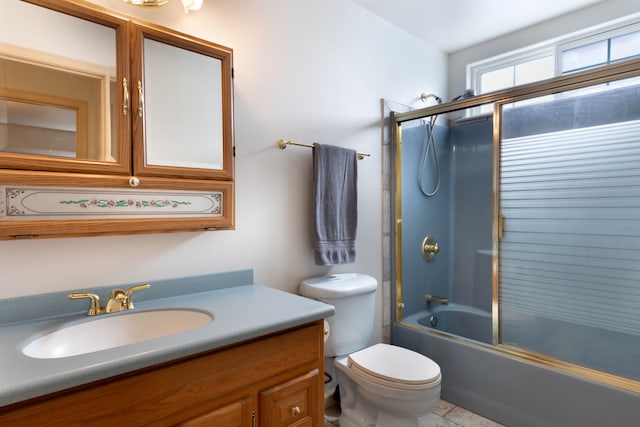 full bathroom featuring toilet, vanity, and shower / bath combination with glass door