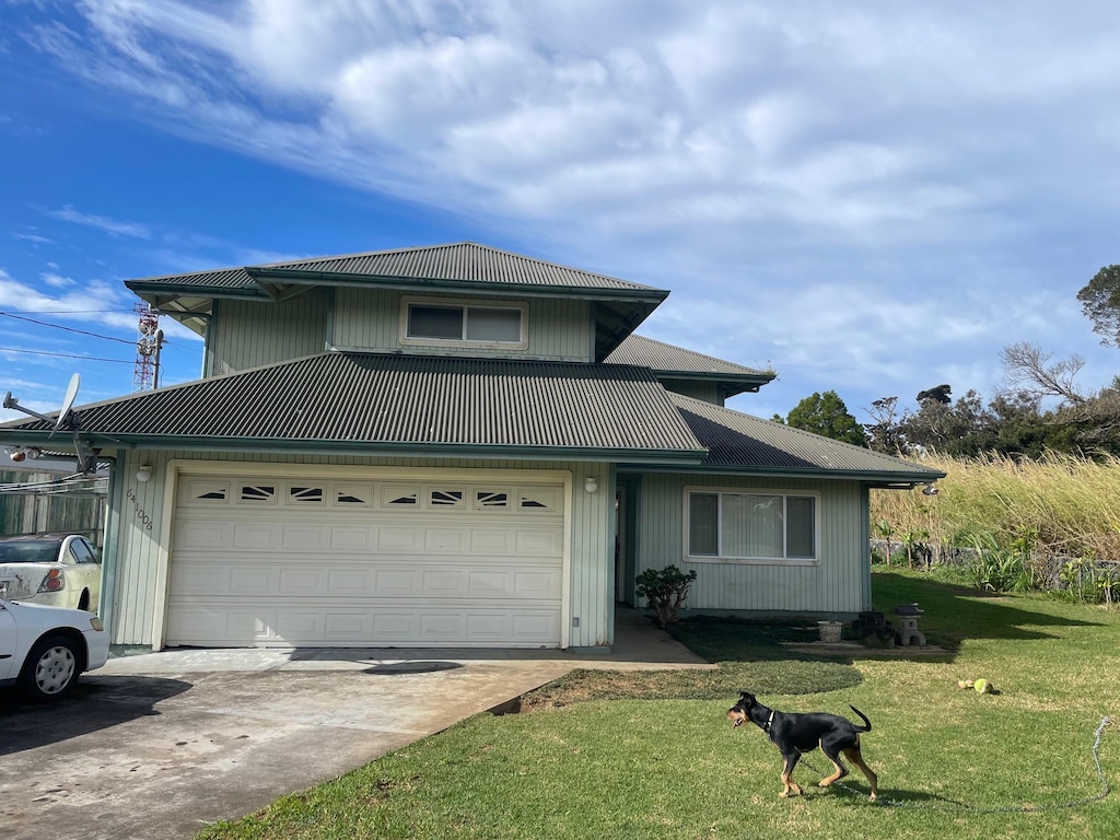 front facade with a front yard and a garage