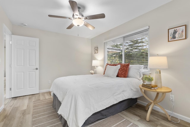 bedroom with ceiling fan and light hardwood / wood-style floors