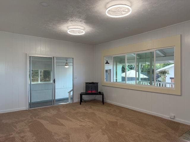 carpeted spare room featuring a textured ceiling