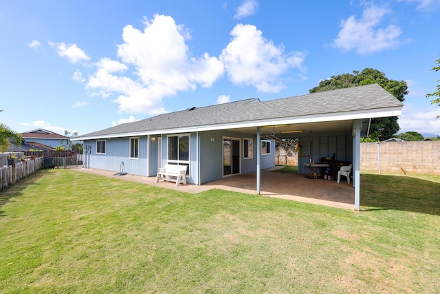 back of house featuring a patio area and a yard