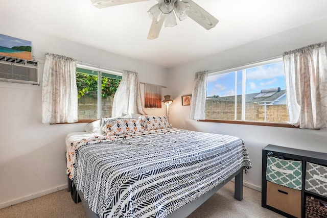 bedroom featuring light carpet, ceiling fan, and a wall mounted AC