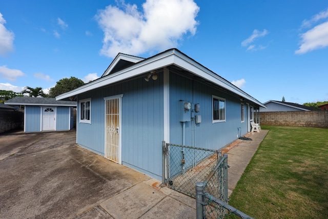 view of property exterior with a yard and a storage shed