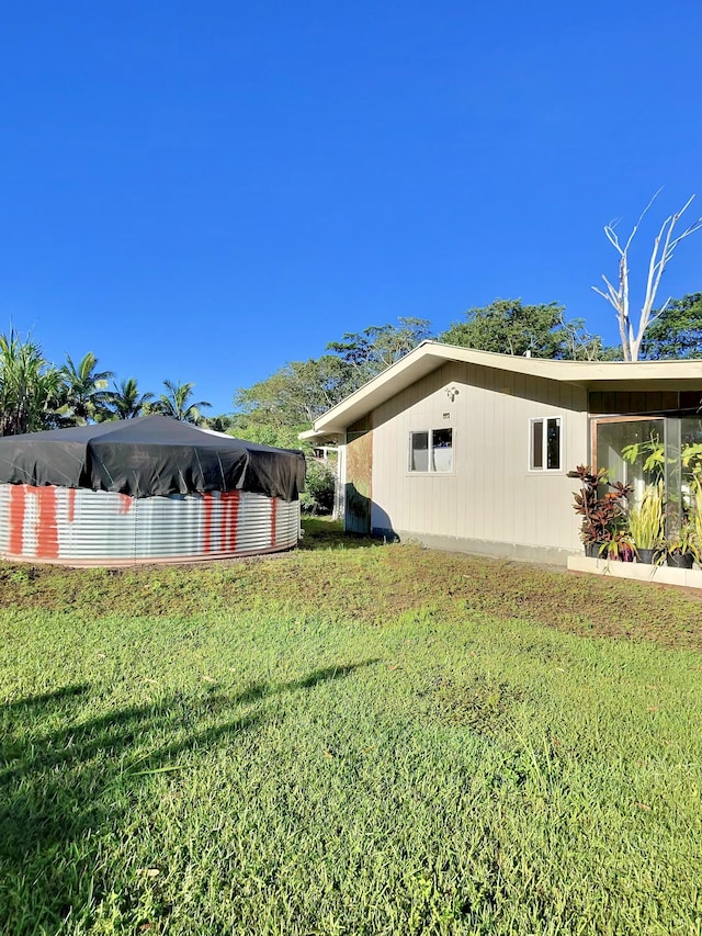 view of side of home with a lawn