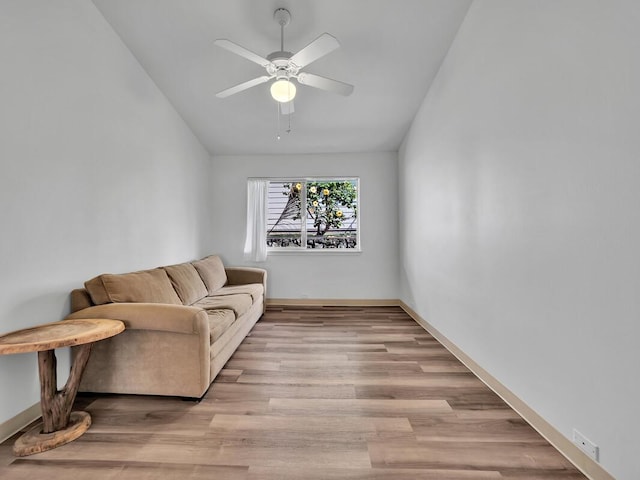 living room with ceiling fan and light wood-type flooring