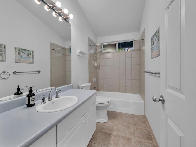 full bathroom featuring toilet, vanity, tiled shower / bath combo, and tile patterned flooring