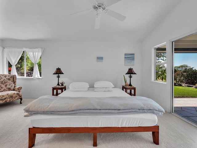 carpeted bedroom featuring ceiling fan, access to exterior, and lofted ceiling