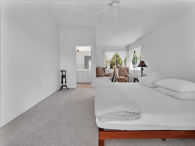 carpeted bedroom with ceiling fan and ensuite bath