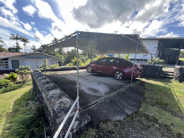 view of parking / parking lot with a carport and a lawn