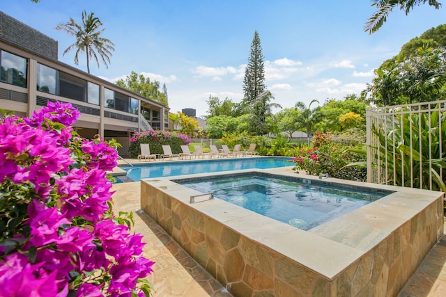 view of pool featuring a hot tub