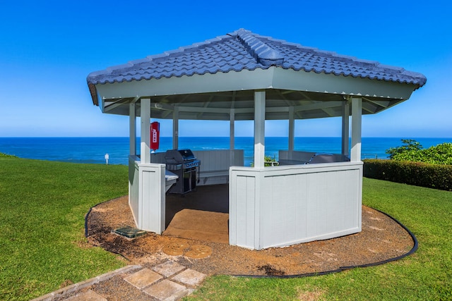 view of patio / terrace with a gazebo, grilling area, and a water view