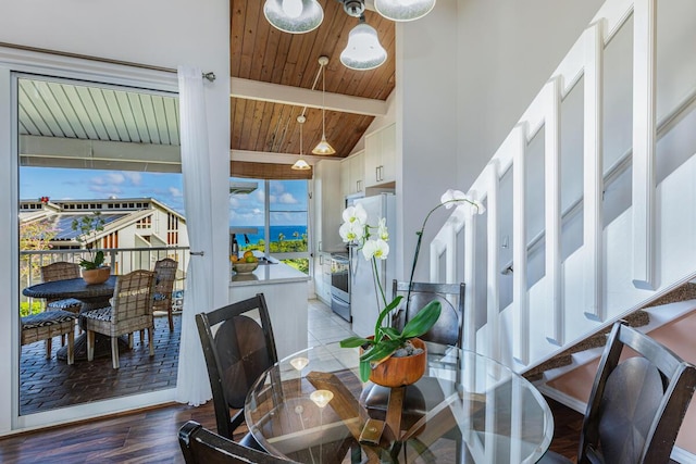 dining area featuring wood-type flooring, beam ceiling, high vaulted ceiling, and wooden ceiling