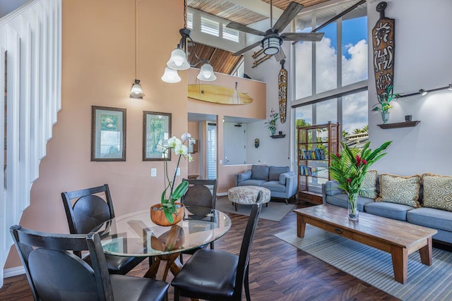 dining area featuring a towering ceiling and ceiling fan