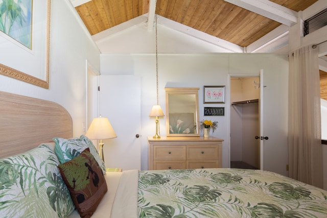 bedroom with lofted ceiling, wood ceiling, a walk in closet, and a closet