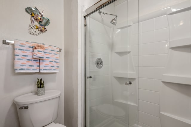 bathroom featuring toilet and walk in shower